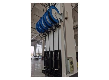 Industrial hose reel mounted at a workstation